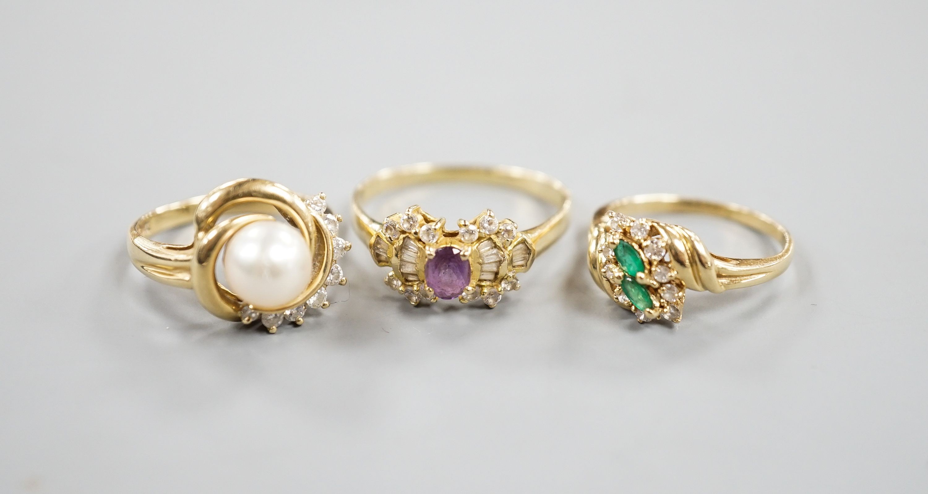 Three assorted modern 14k yellow metal and gem set dress rings, including cultured pearl and diamond, gross weight 10 grams.